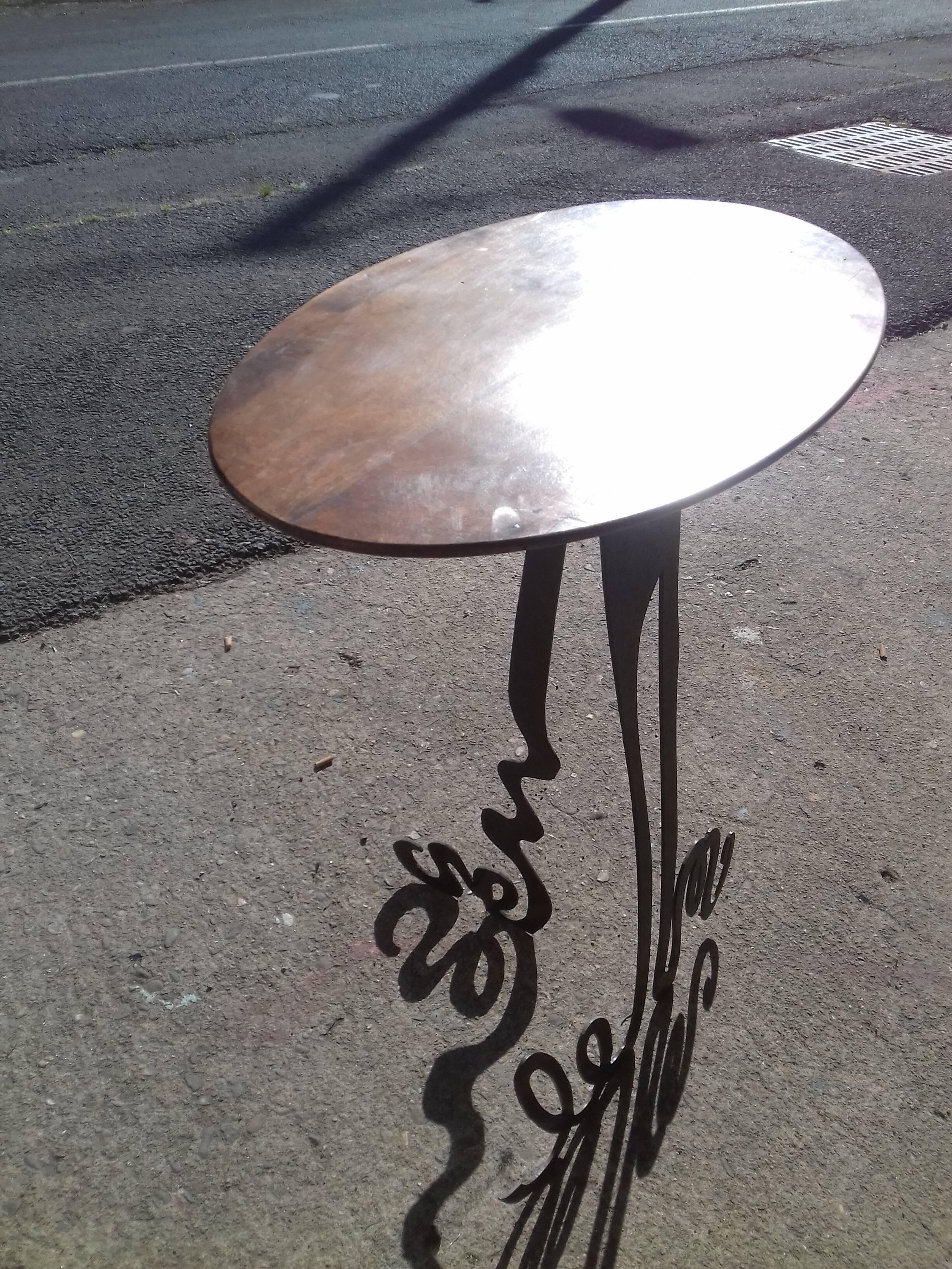 Steel side table with an oval walnut top