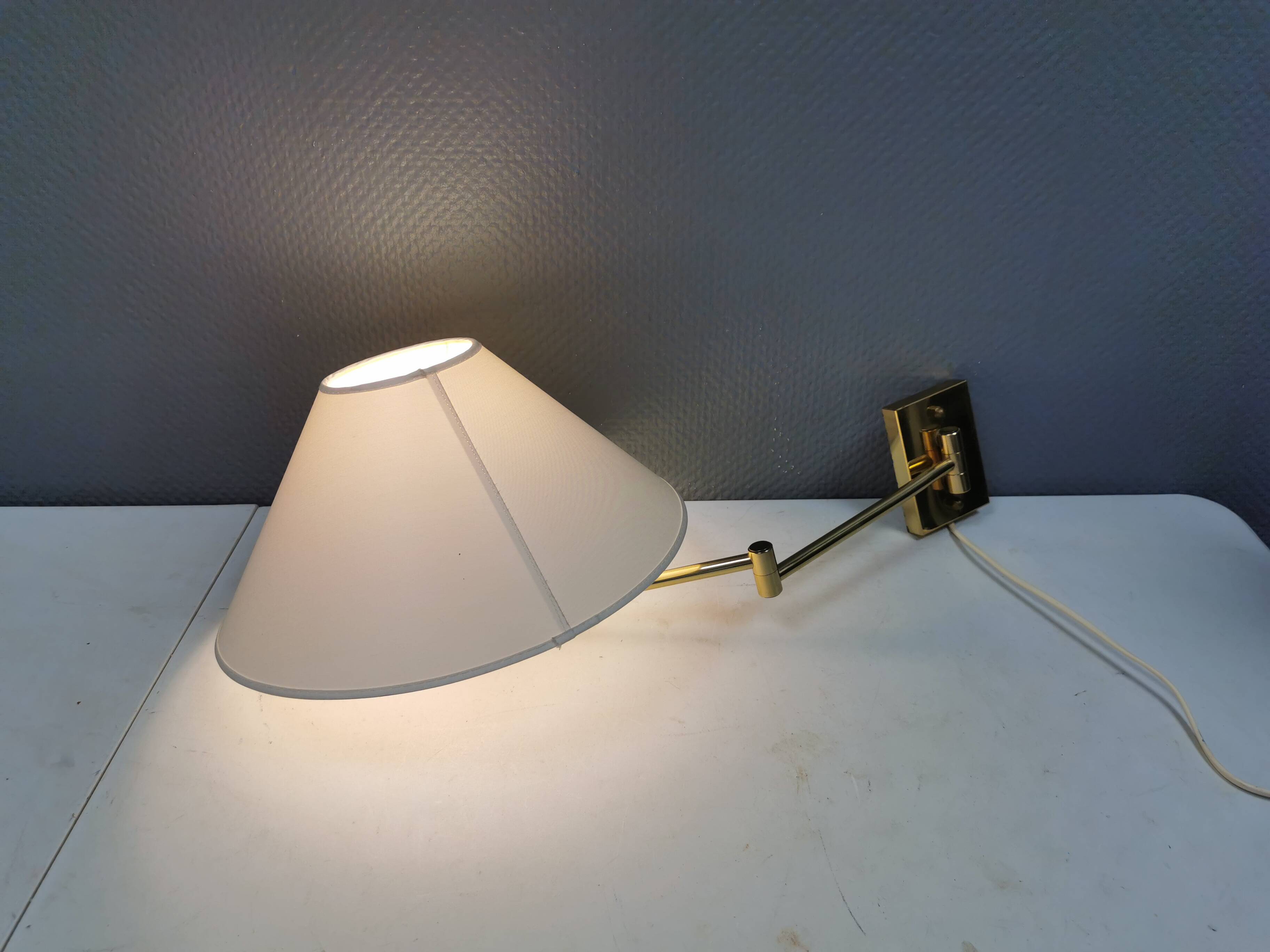 Danish Brass wall lamp with a ‘swivel’ effect.