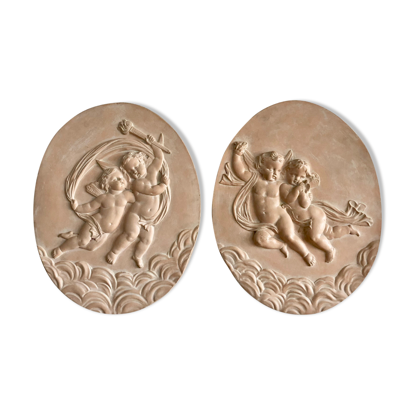 Pair of putti medallions