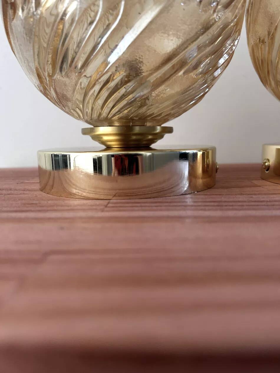 Pair of golden globe wall lights