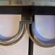 Pair of stainless steel and brass wall lights