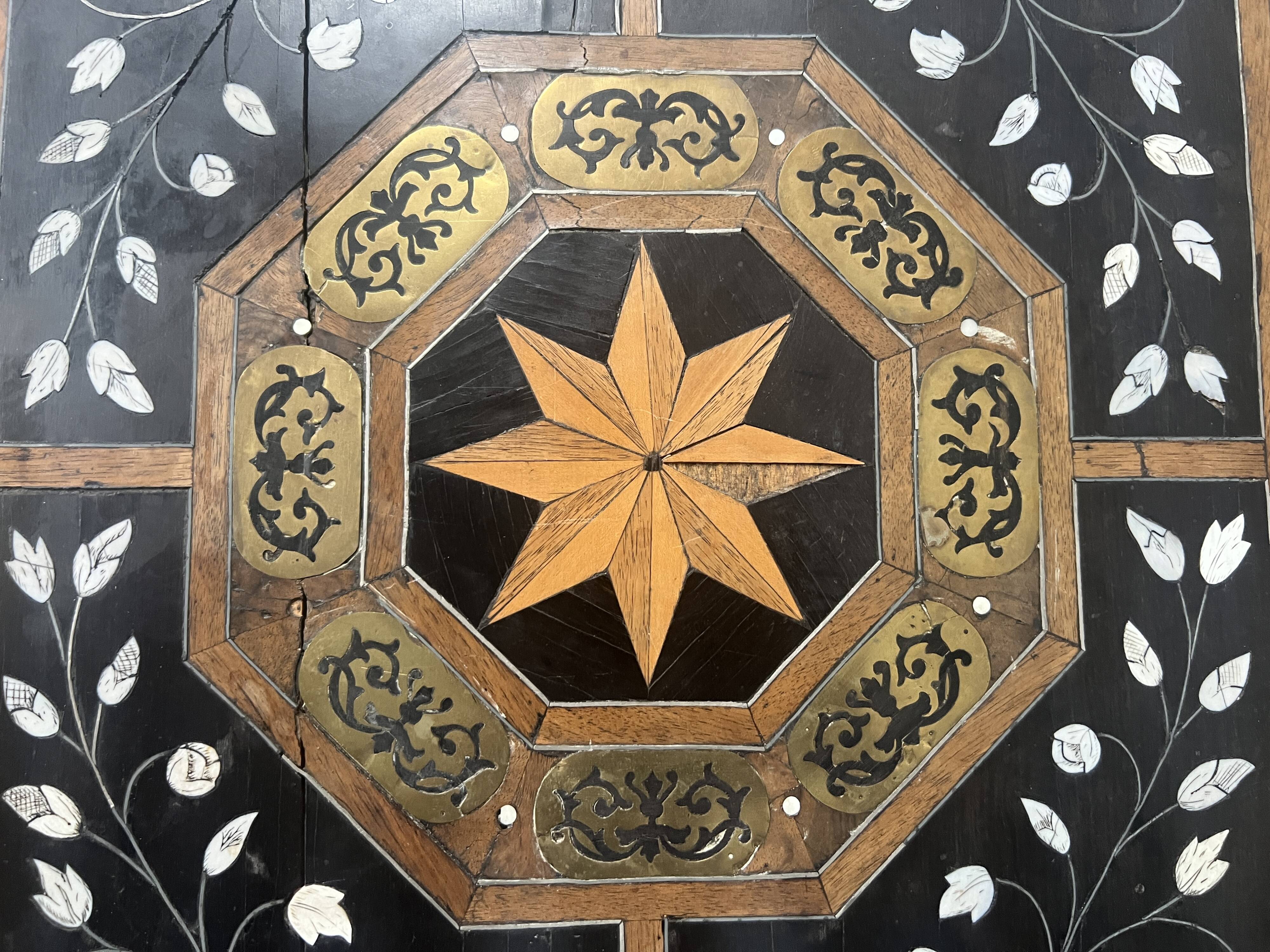 Blackened wood display table with marquetry top, Spain, 19th century.