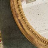Oval mirror in gilded wood.