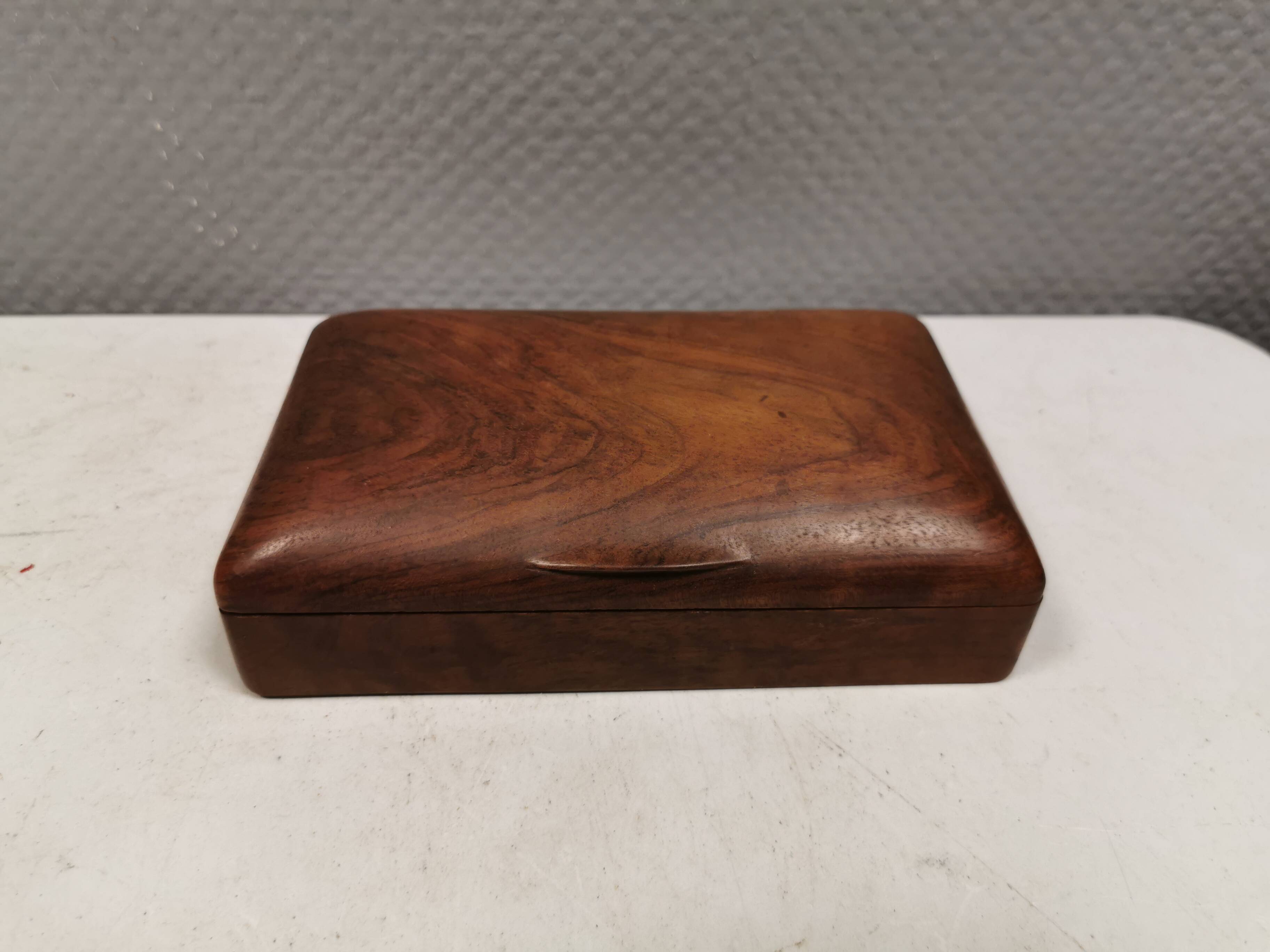 Wooden trinket box for storing jewellery, cigarettes or similar items.