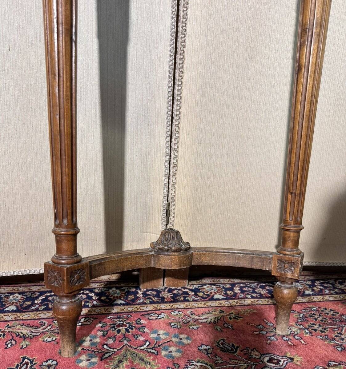 Half-moon console in Louis XVI style made of carved wood.