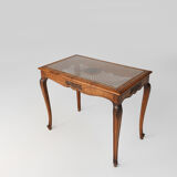 Side table with sculpted elements and rattan top