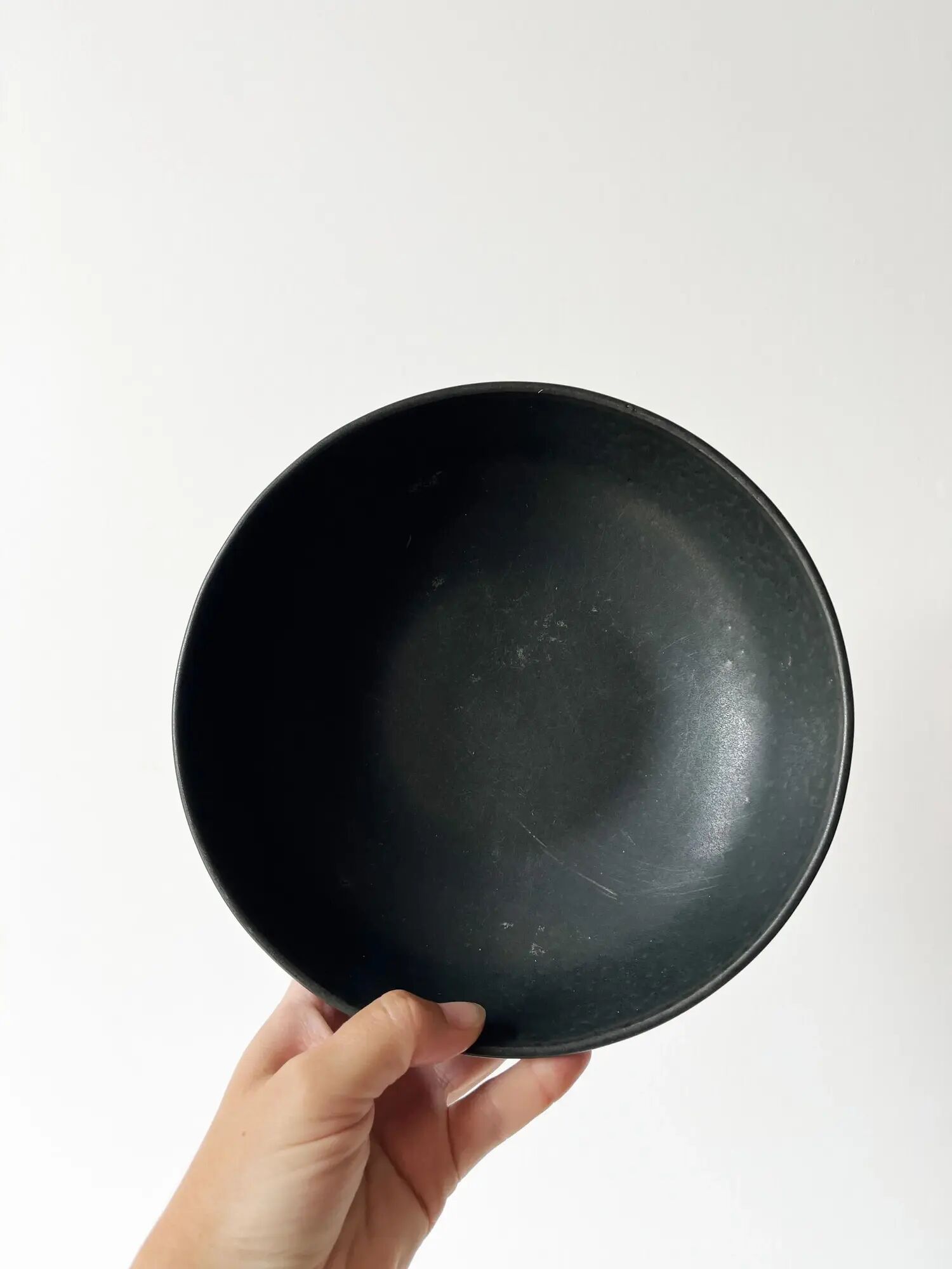 Round vintage black ceramic catchall.