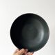 Round vintage black ceramic catchall.