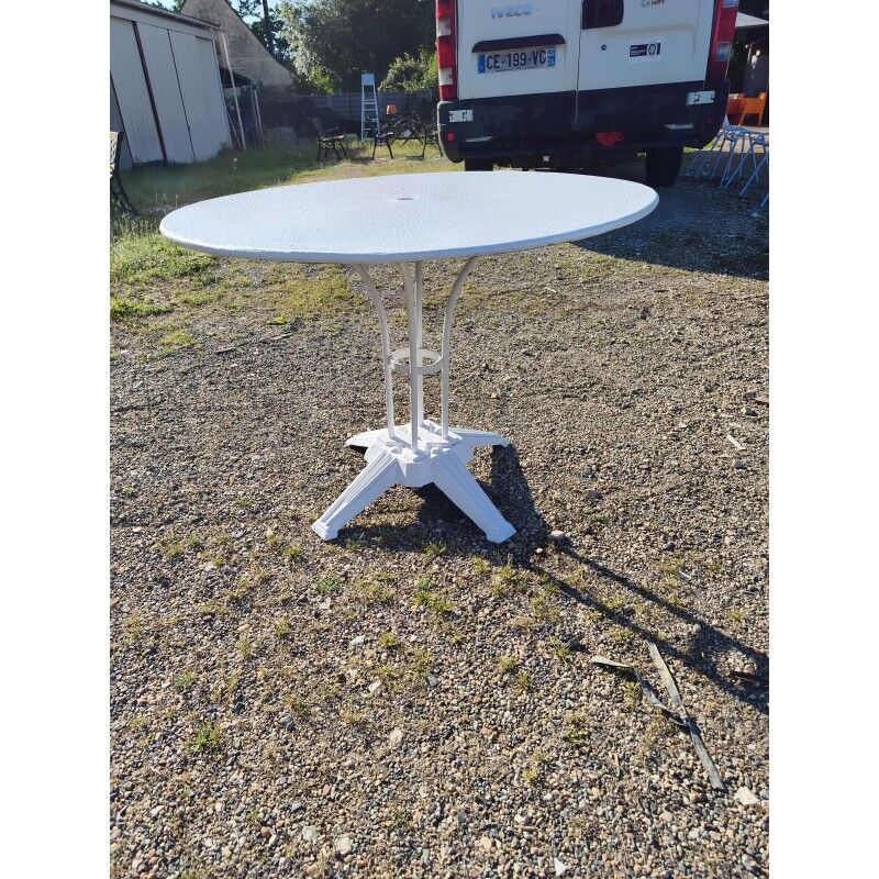 Garden table with a cast iron base and a metal top.