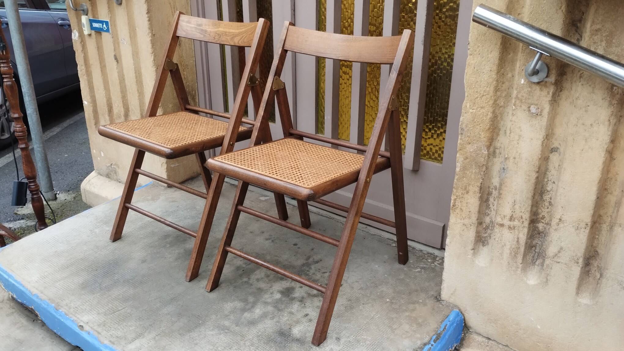 Pair of vintage wooden and cane folding chairs