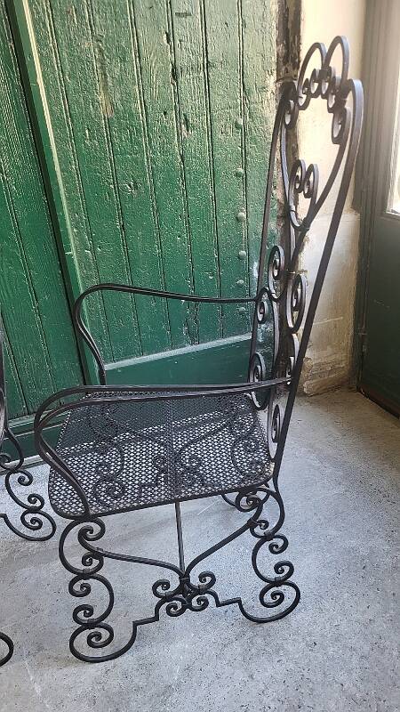 Pair of black wrought iron armchairs