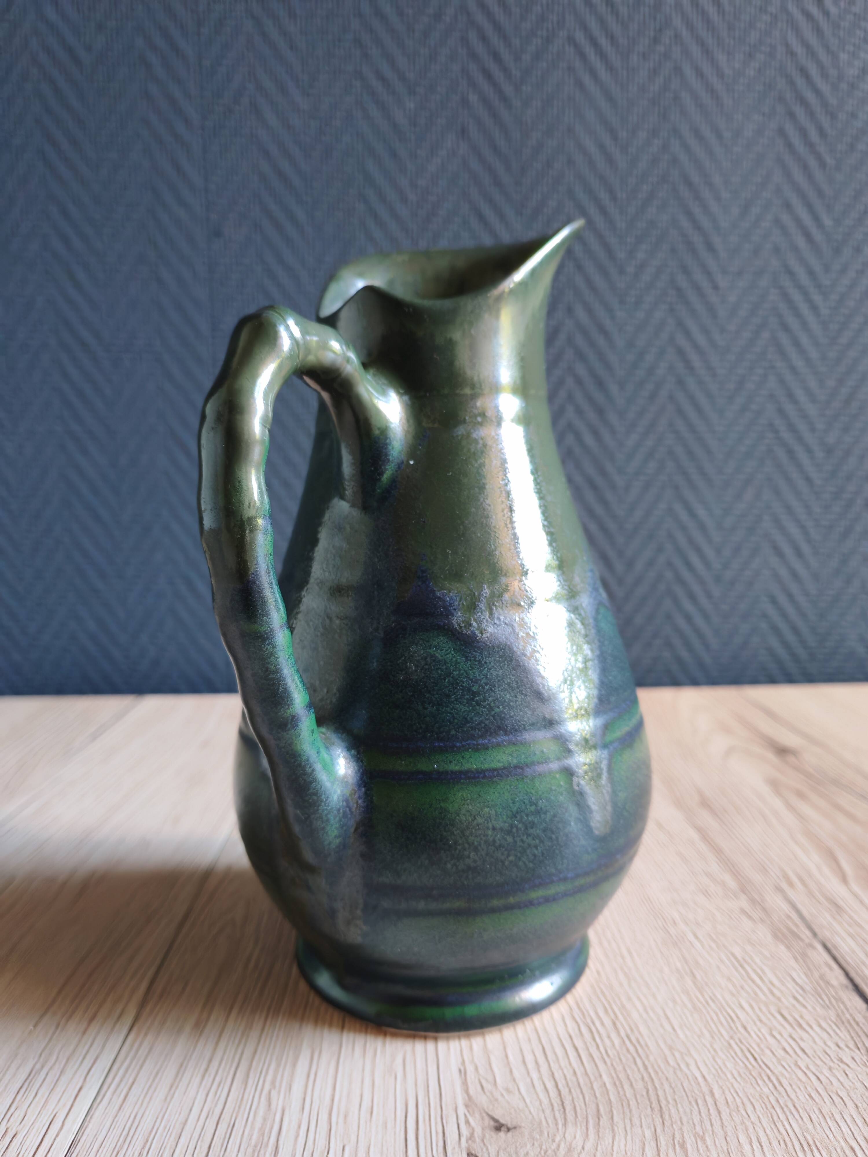 Vintage ceramic pitcher vase in glazed green and blue.