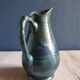Vintage ceramic pitcher vase in glazed green and blue.
