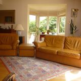 Tan leather sofa with natural graining, matching armchair and pouf