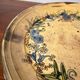 Vintage round ceramic plate with floral decoration.
