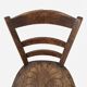 Antique wooden chair with a pyrographed shell motif seat.