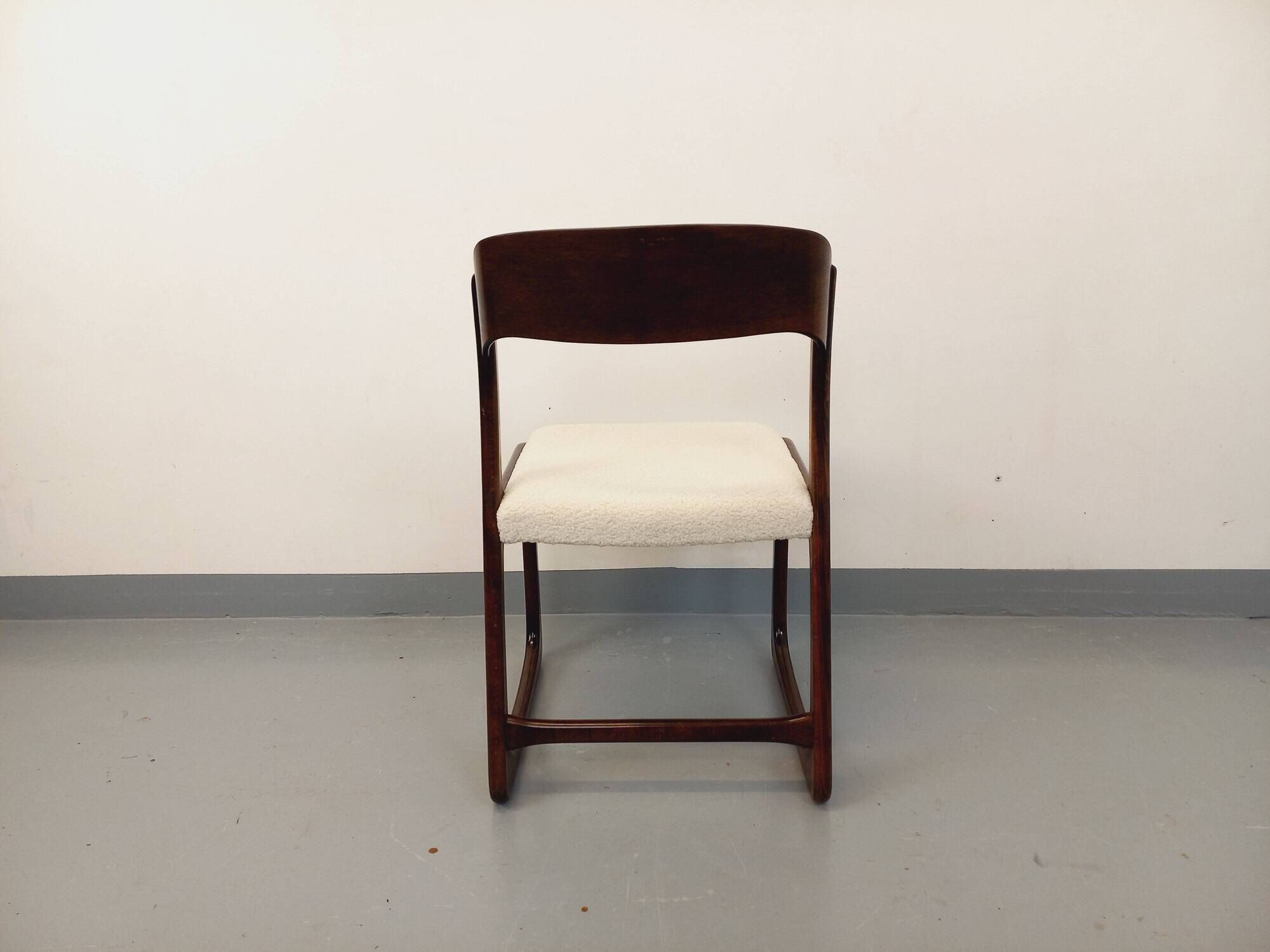 Vintage sled chair by Baumann in wood and boucle fabric.