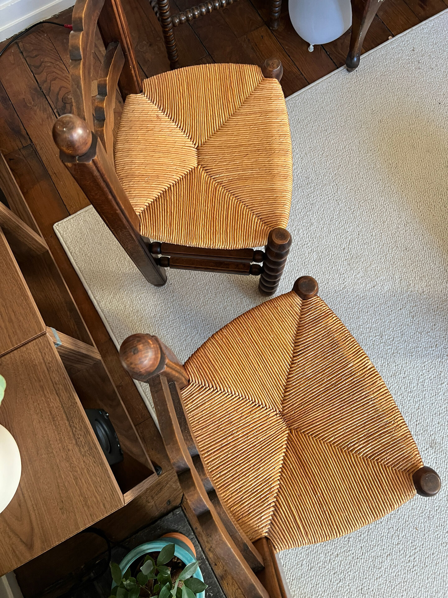 Pair of vintage armchairs with turned wood and woven rope seat.