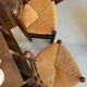Pair of vintage armchairs with turned wood and woven rope seat.