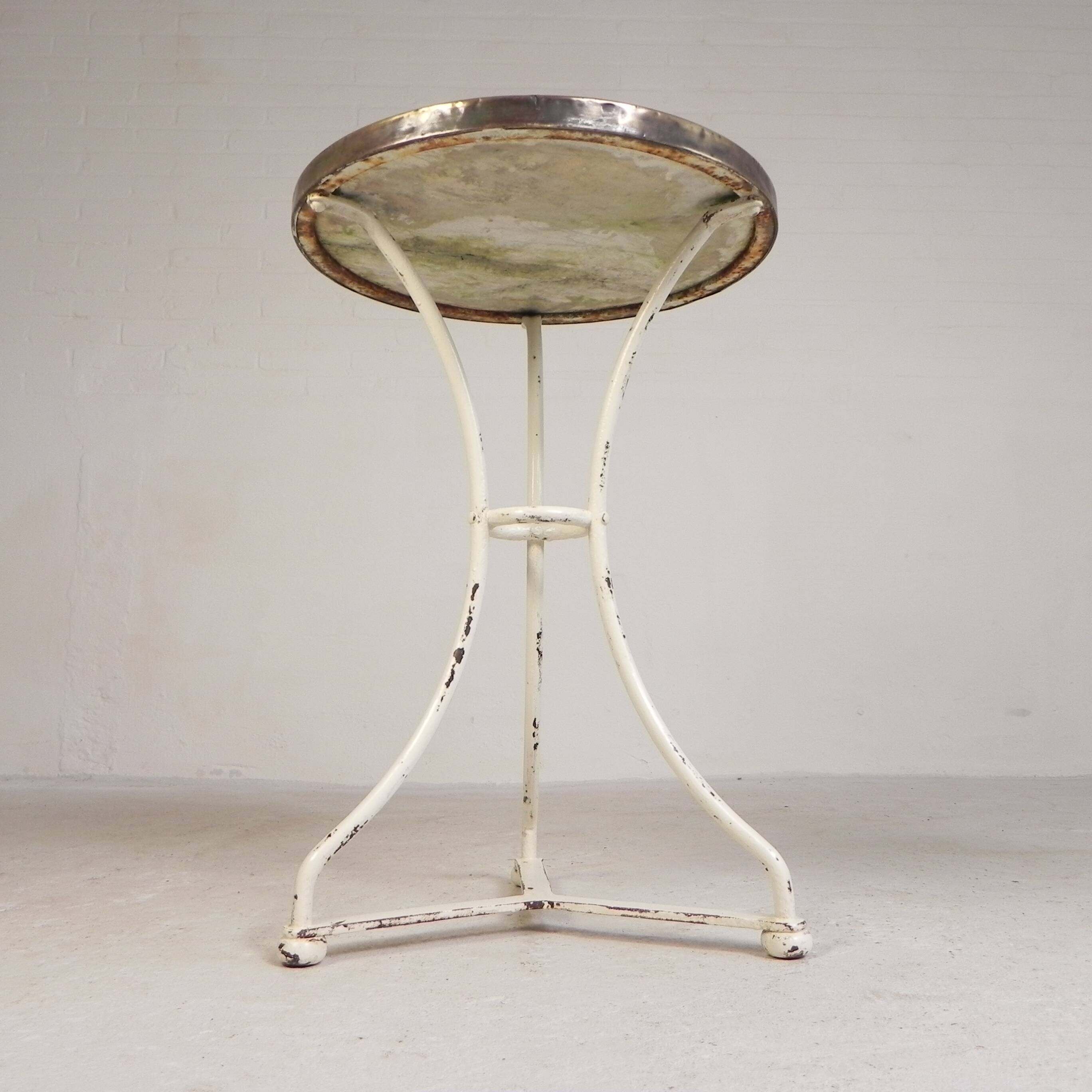 Bistro table with a marble top and brass edging, early 20th century.