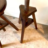 2 tripod stools with dark wood screws
