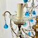 Italian chandelier with blue beads and gilded wood.