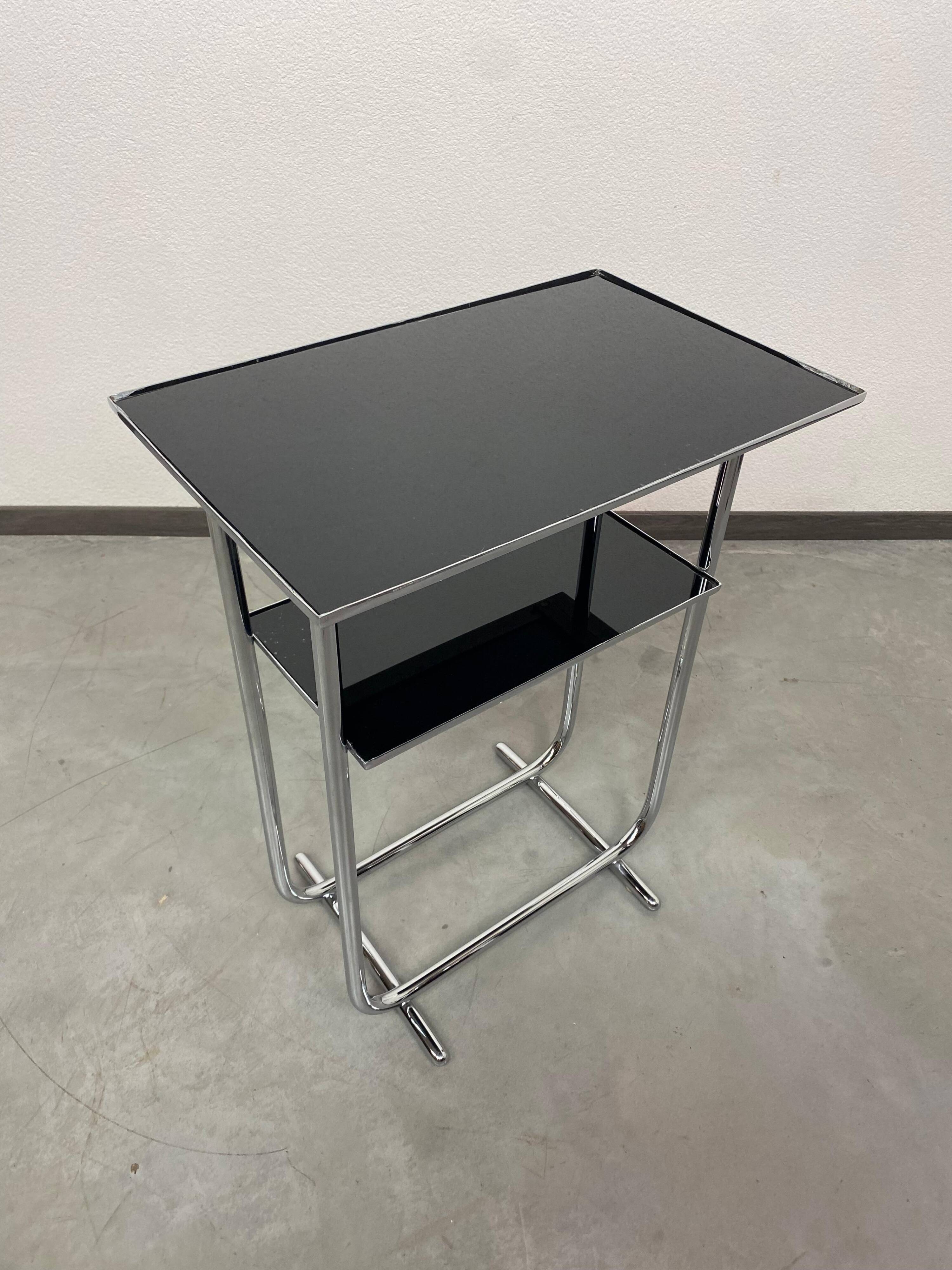Bauhaus side table with a black glass top