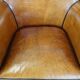 Cognac-colored sheep leather armchair finished with decorative nails
