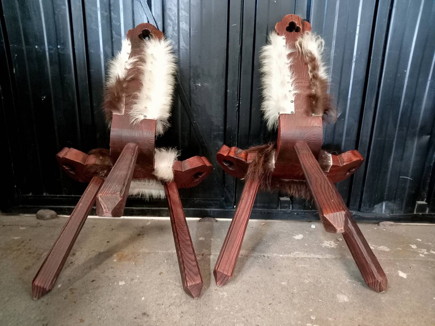 Pair of brutalist tripod chairs in wood and cowhide