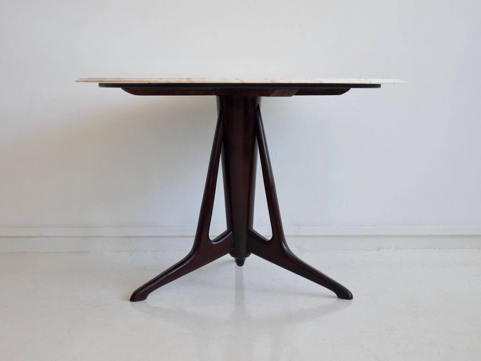 Mid-century modern round dining table in marble and ebony wood.