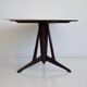 Mid-century modern round dining table in marble and ebony wood.