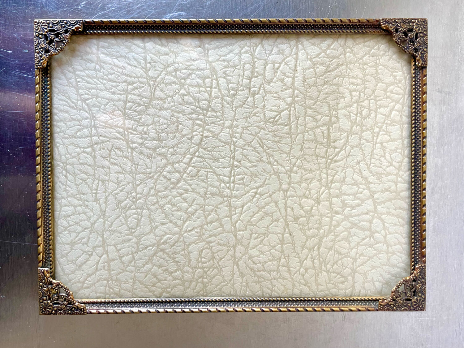 Metal frame in gold colored brass