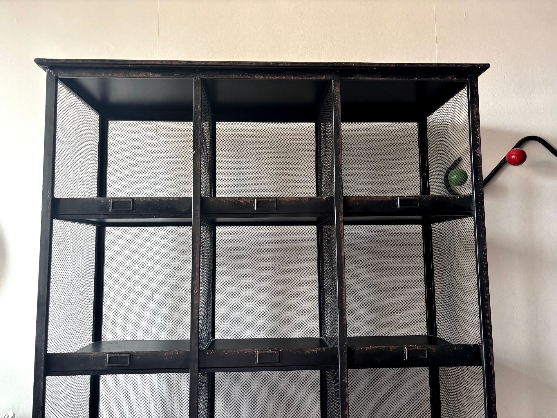 Black metal shelf with compartments.