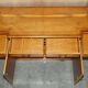 Vintage buffet made of mottled yew wood with three doors and four drawers.