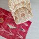 Beige toad armchair with floral patterns and red fringes