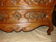 A Regency-era commode from the late 17th century, made of solid cherry wood.