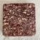 Pink marble trivet with brass ball feet.