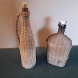Set of two glass and wicker bottles