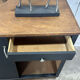 Small vintage black buffet with sliding doors.