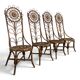 Set of 4 bamboo and rattan chairs with sunflower decoration.