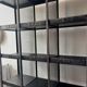Black metal shelf with compartments.