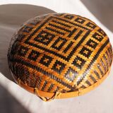 Woven patterned basket, made of straw and bamboo.