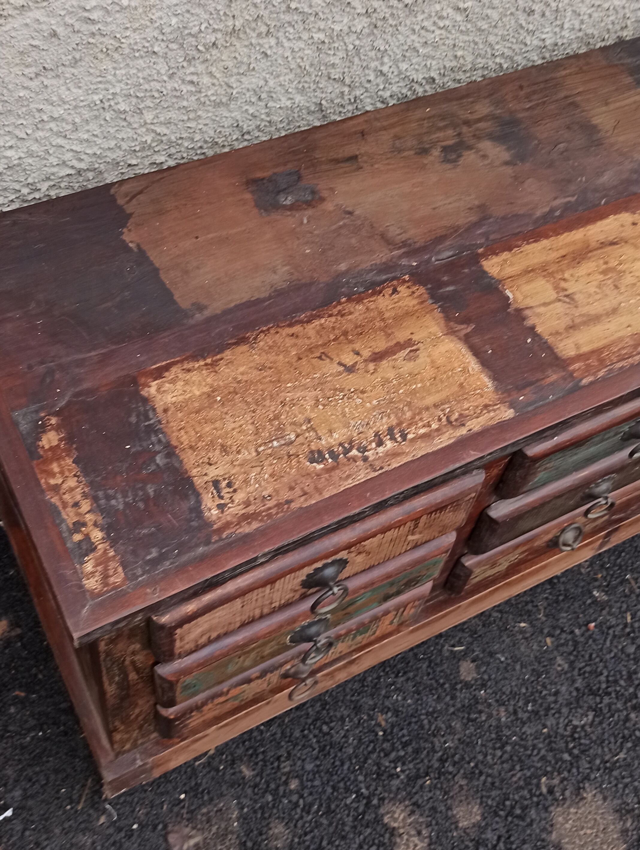 Furniture low in colorful wood. 12 drawers and 1 door