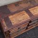 Furniture low in colorful wood. 12 drawers and 1 door