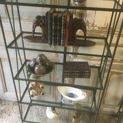 Pair of wrought iron and glass bookshelf shelves.