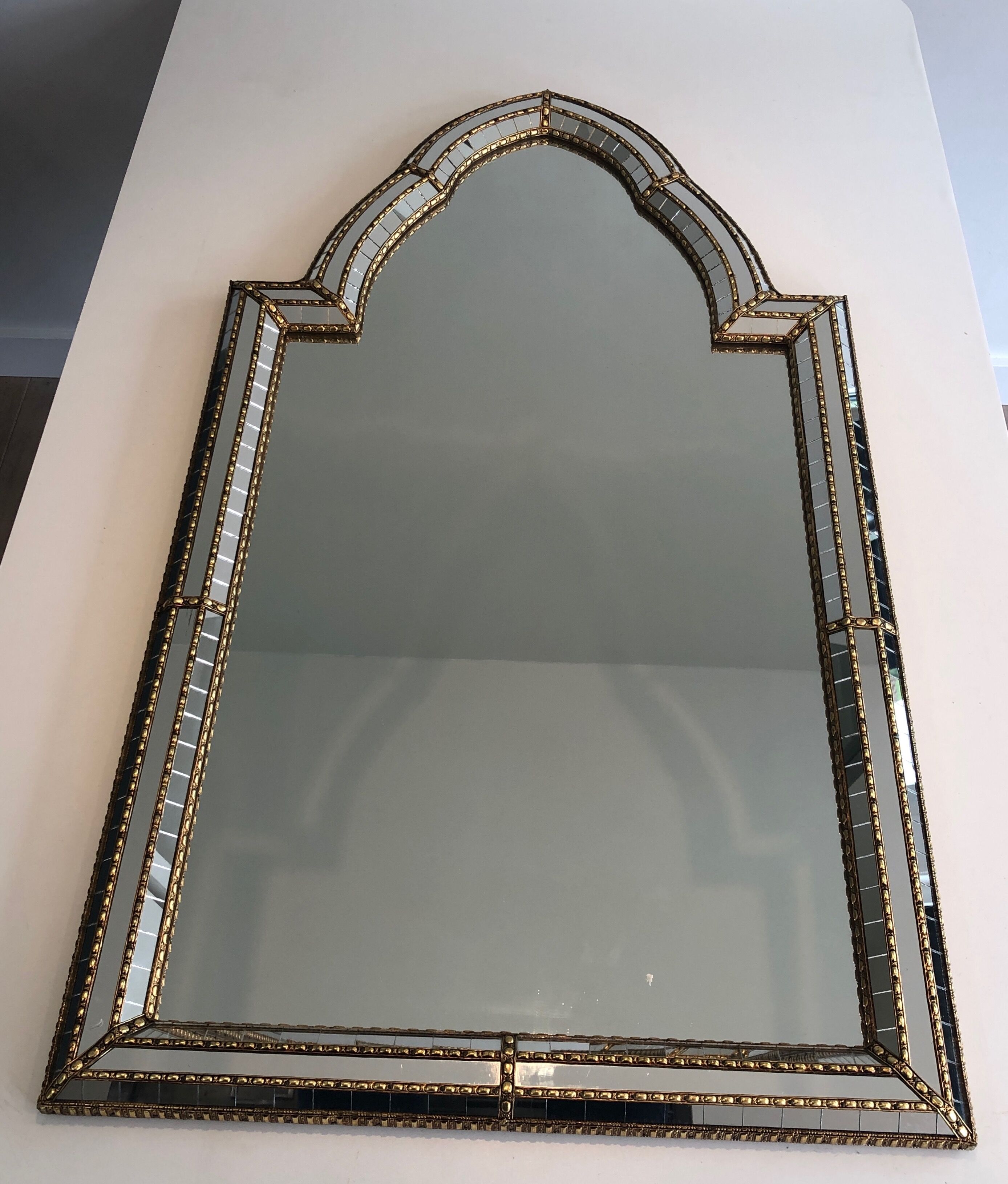 Mirror consisting of multi-faceted mirrors and brass garlands, French work, around 1970