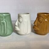 Set of three small Moai-style head vases.