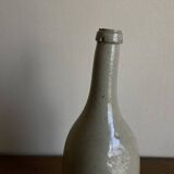 Stoneware bottle tilted at an angle, early 20th century