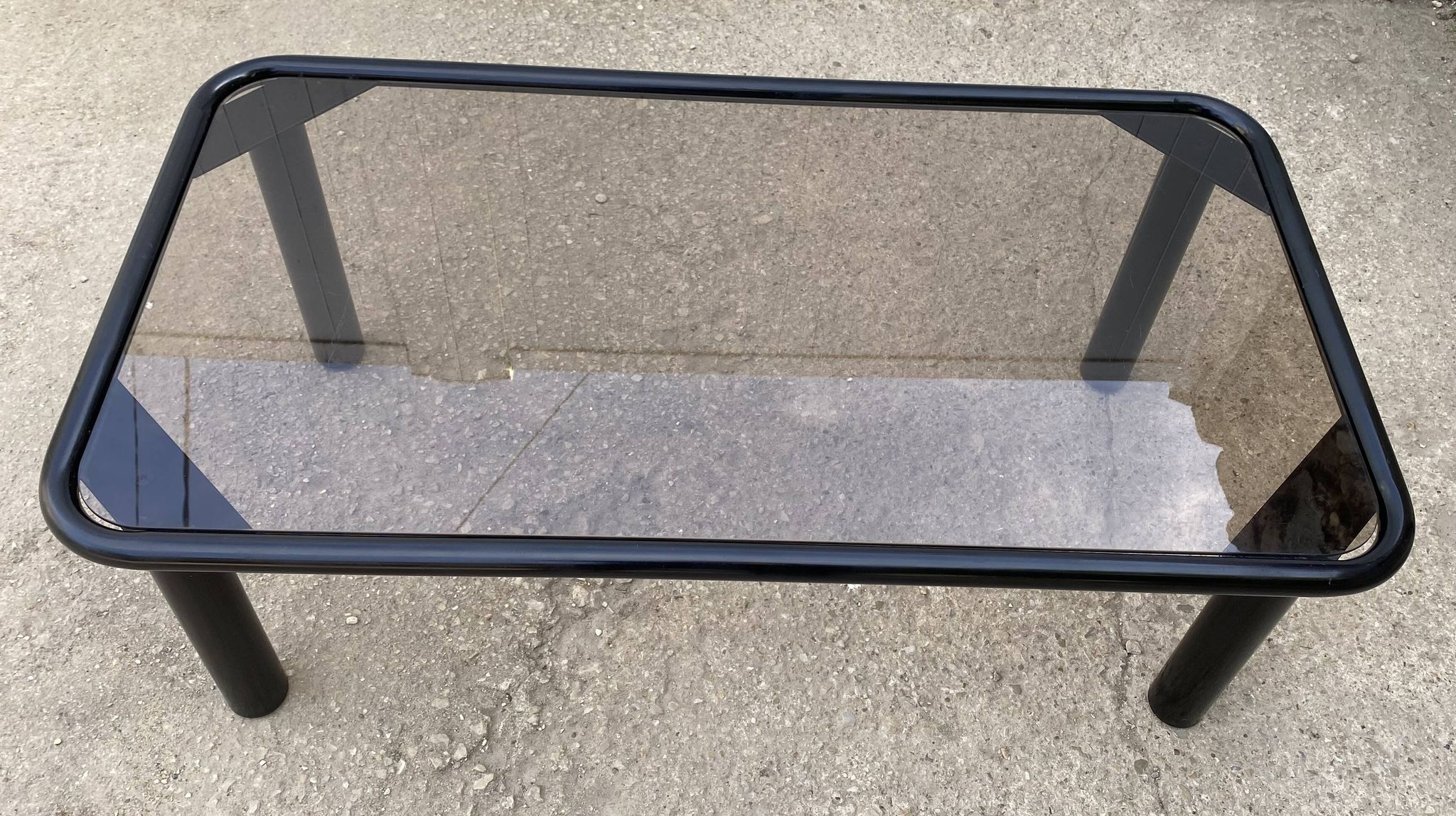 Vintage black tubular coffee table with smoked glass by Yves Boutboul, 1980.