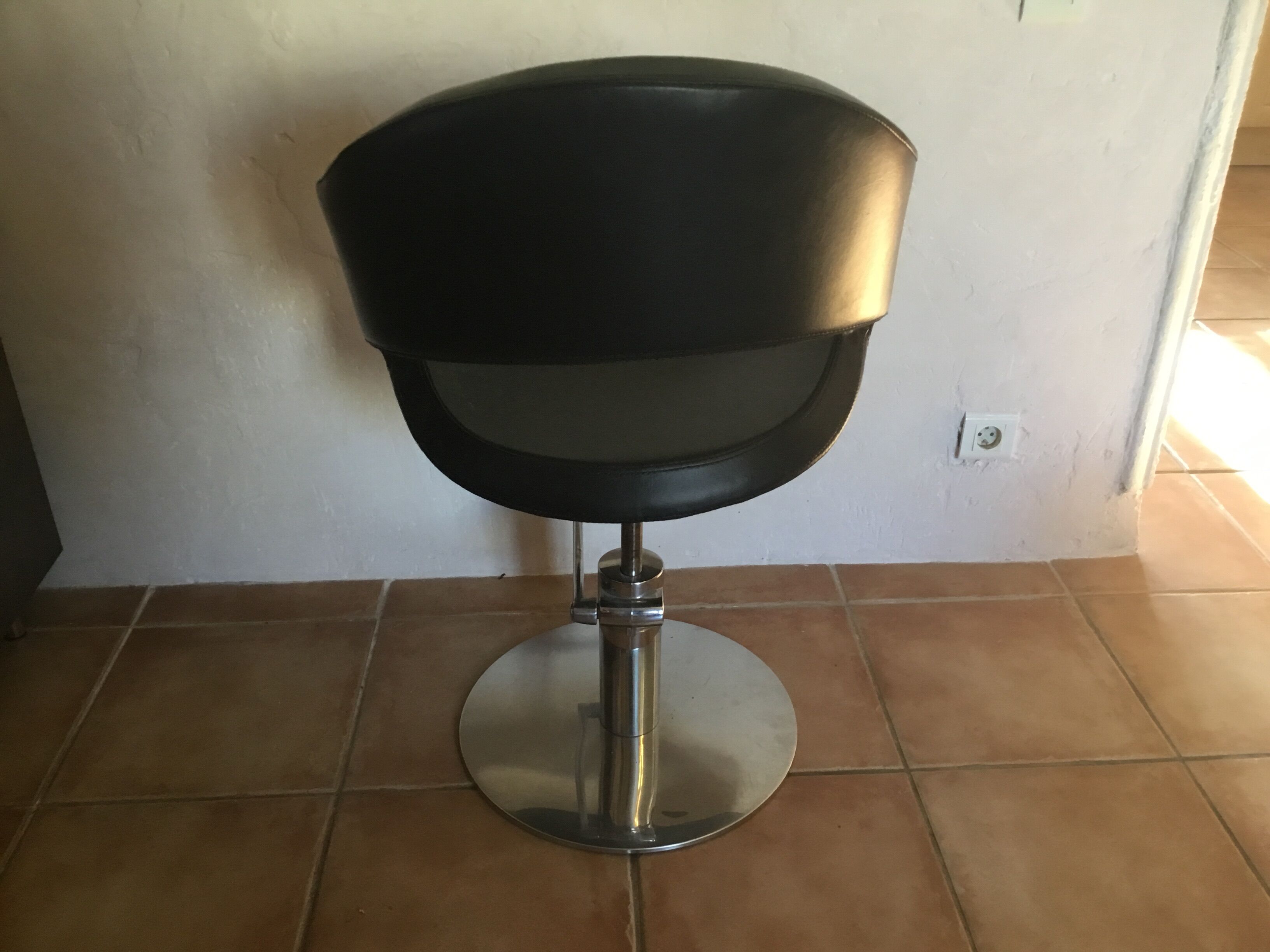 Professional vintage chair sitting in leather and chrome feet adjustable